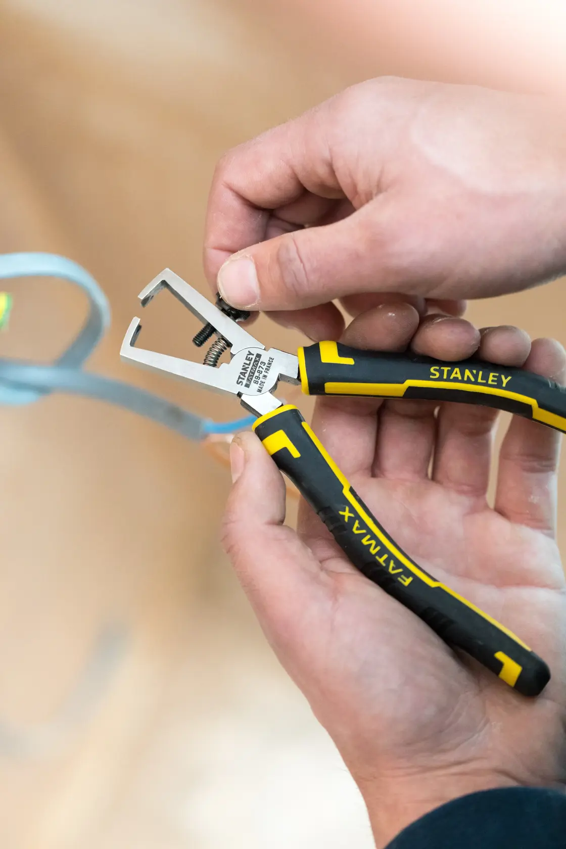 Stanley wire stripper tool with black and yellow handles, suitable for electrical work and cable stripping tasks.