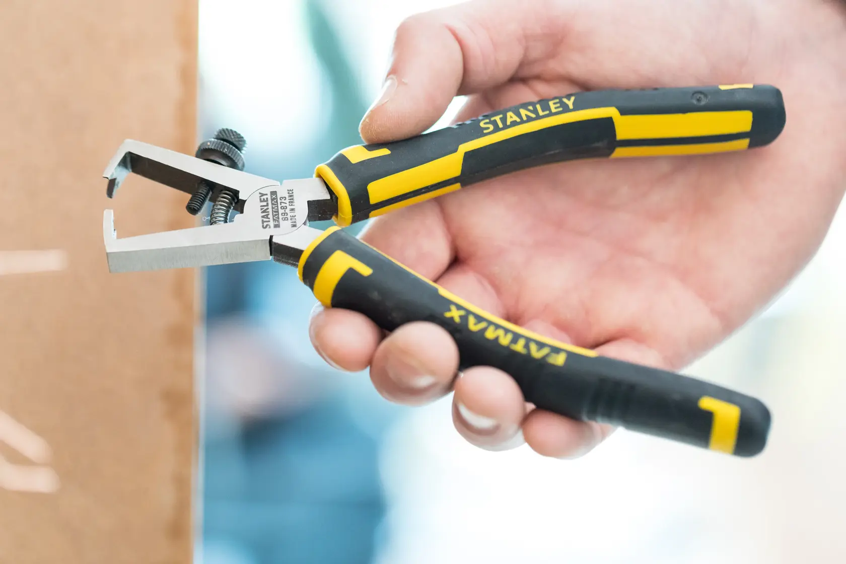 Stanley wire stripping pliers with black and yellow handles, suitable for electrical and photography work.
