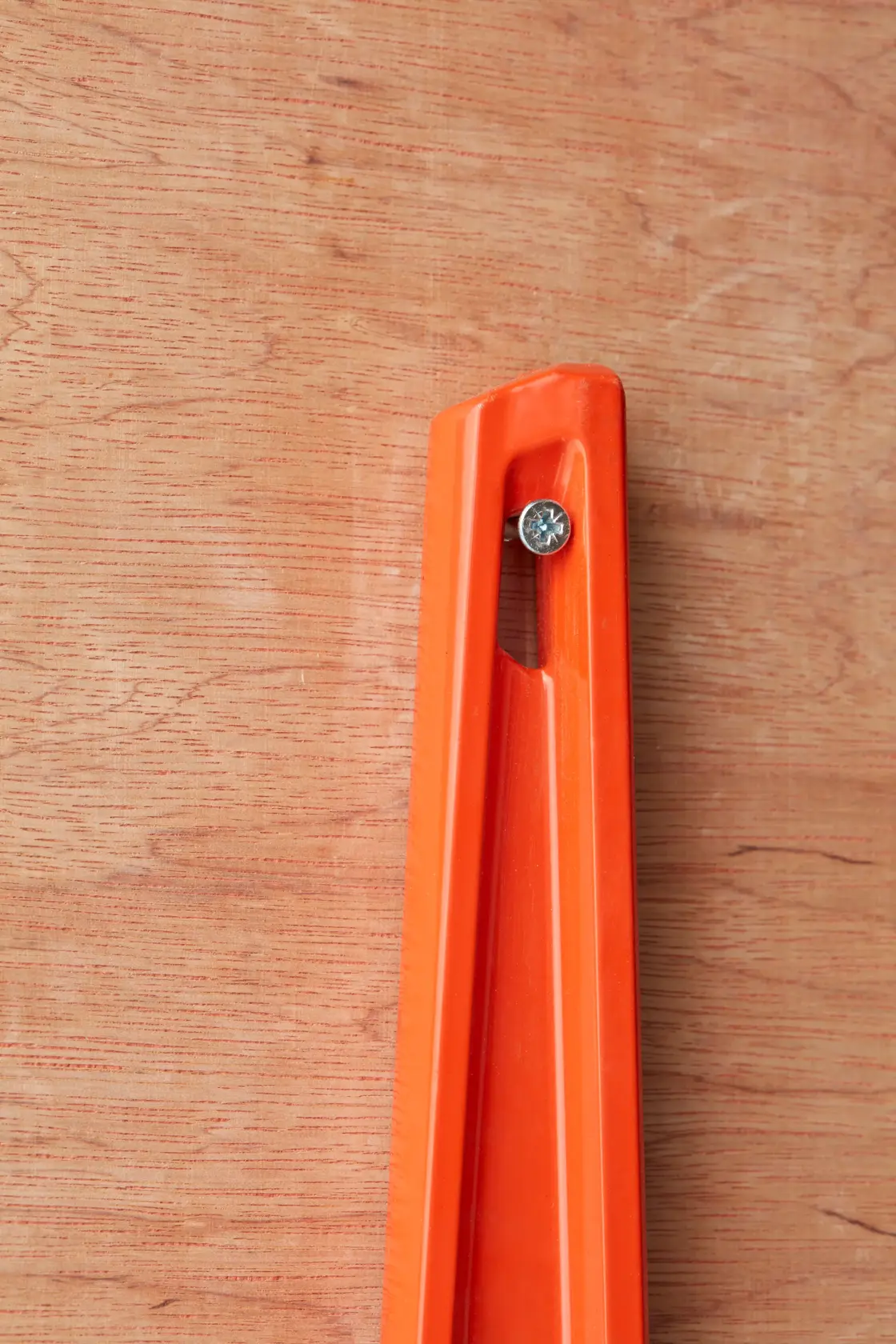 Red STANLEY spirit level with two bubble vials, elongated design, used for precise leveling tasks.