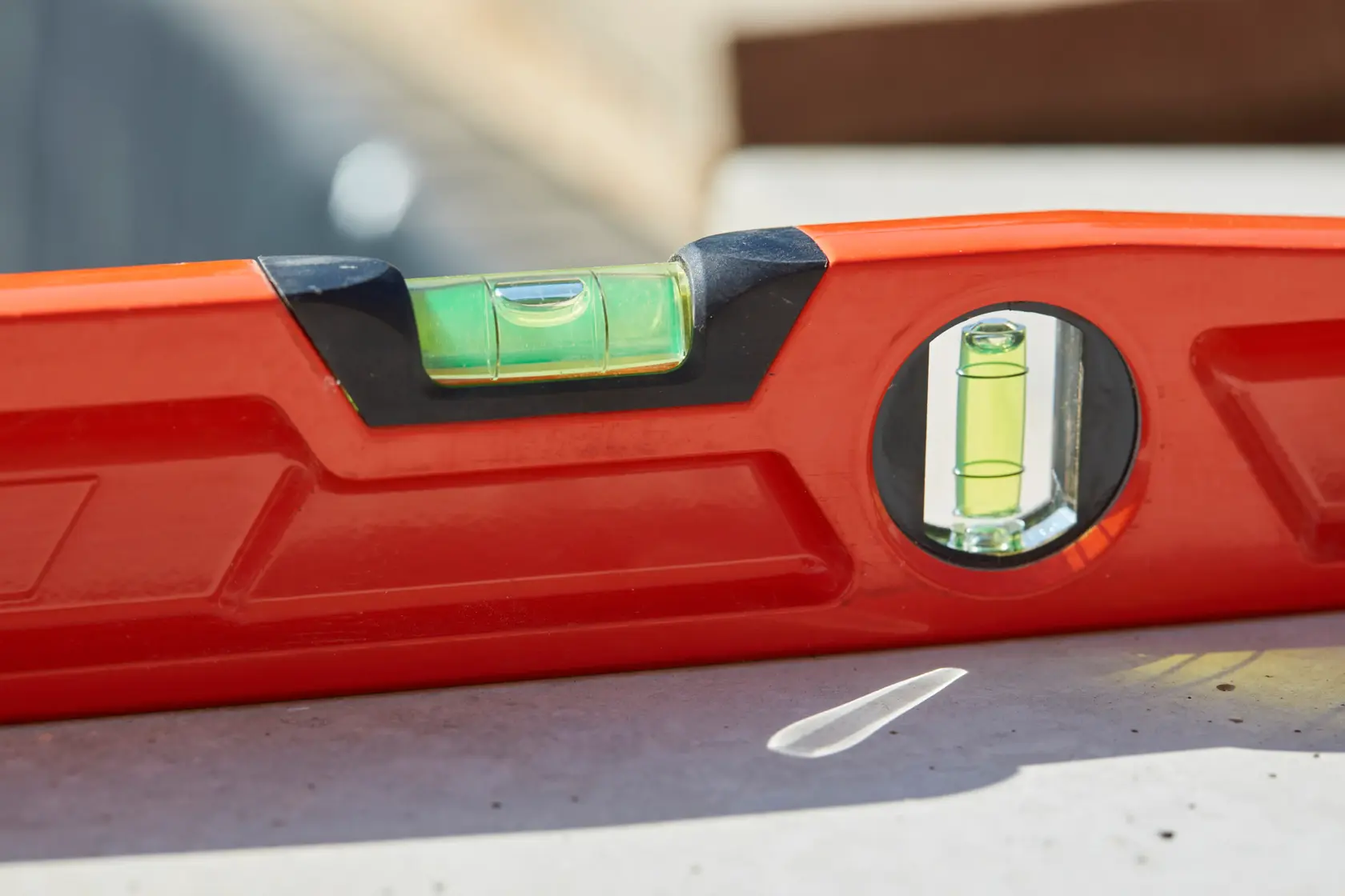Red Stanley spirit level tool with two bubble vials, designed for precise leveling in construction and photography.