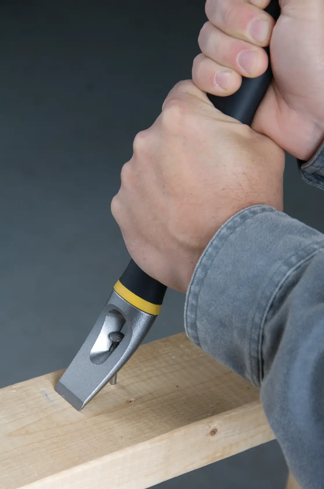 Stanley multi-purpose pry bar with a black and yellow handle, featuring serrated jaws and a nail puller end.