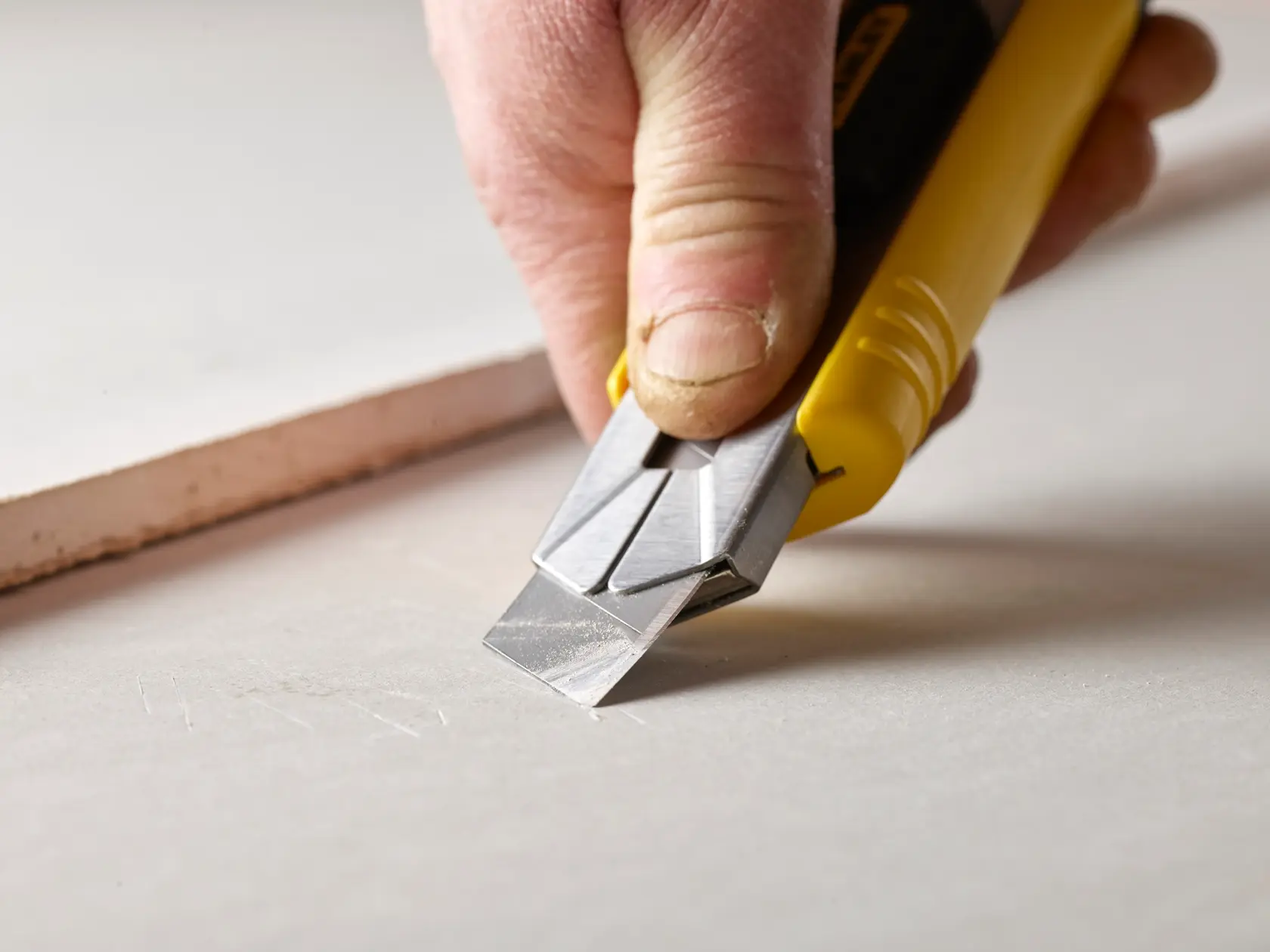 STANLEY 3-11-725 snap-off utility knife blades with black plastic storage case, angled side view on white background.