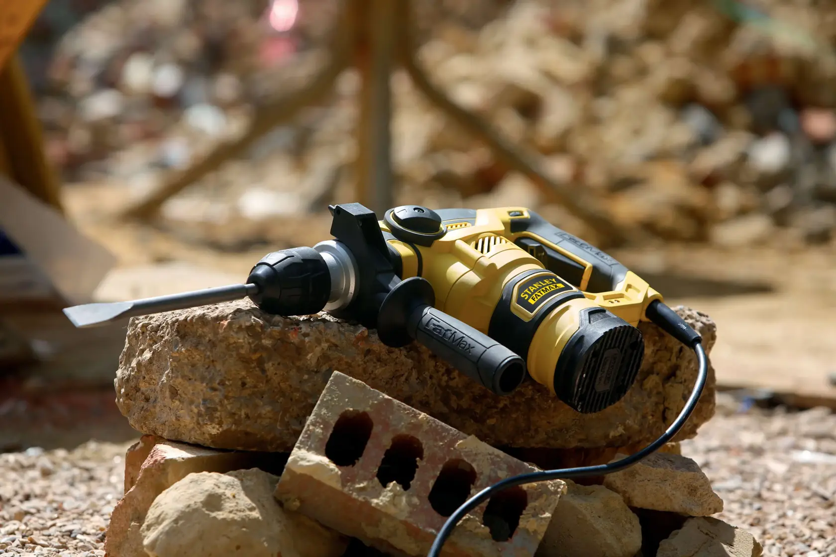 Martello rotativo STANLEY FME1250K in uso su cemento in cantiere, fotografia ravvicinata.