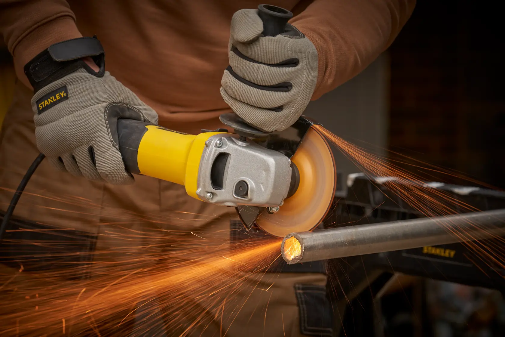 Stanley Fatmax electric angle grinder with yellow and black casing, shown from the side.