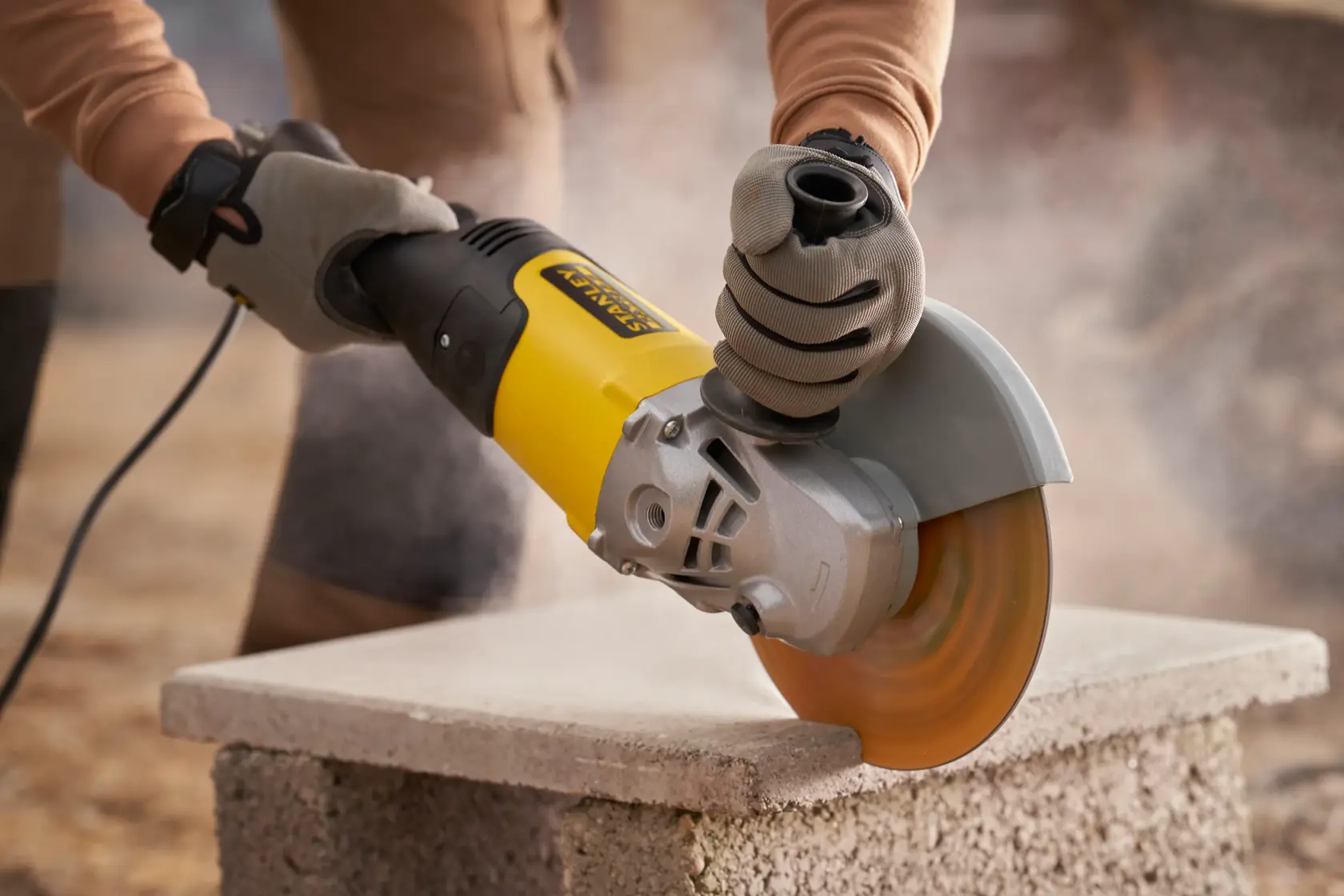 Stanley Fatmax electric angle grinder with yellow and black housing, side view on white background.