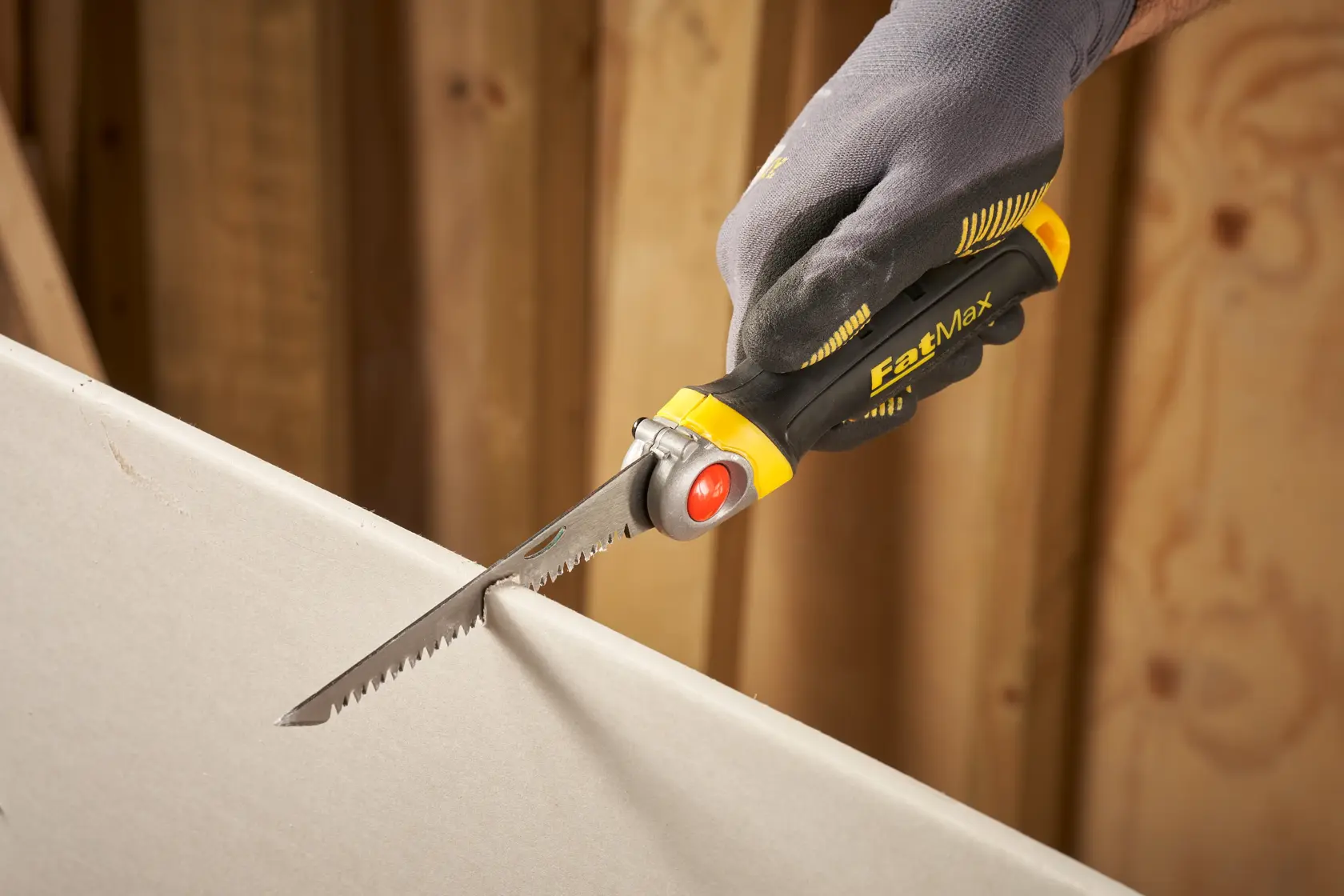 STANLEY FMHT0-20559 drywall saw with ergonomic handle in use, close-up side angle.