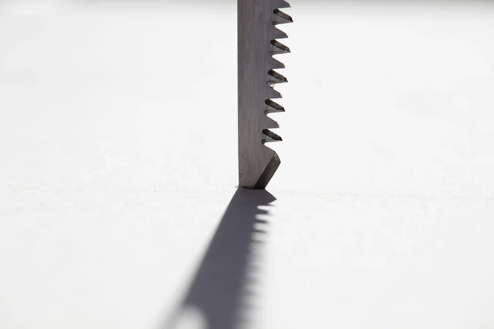STANLEY FMHT0-20559 saw blade close-up, vertical angle, sharp teeth casting shadow on white background