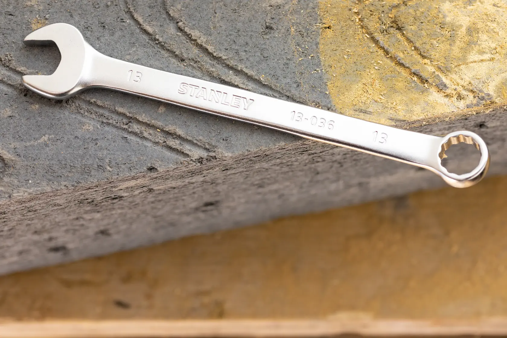 STANLEY FMMT13032-0 combination wrench, silver, angled view on textured surface.