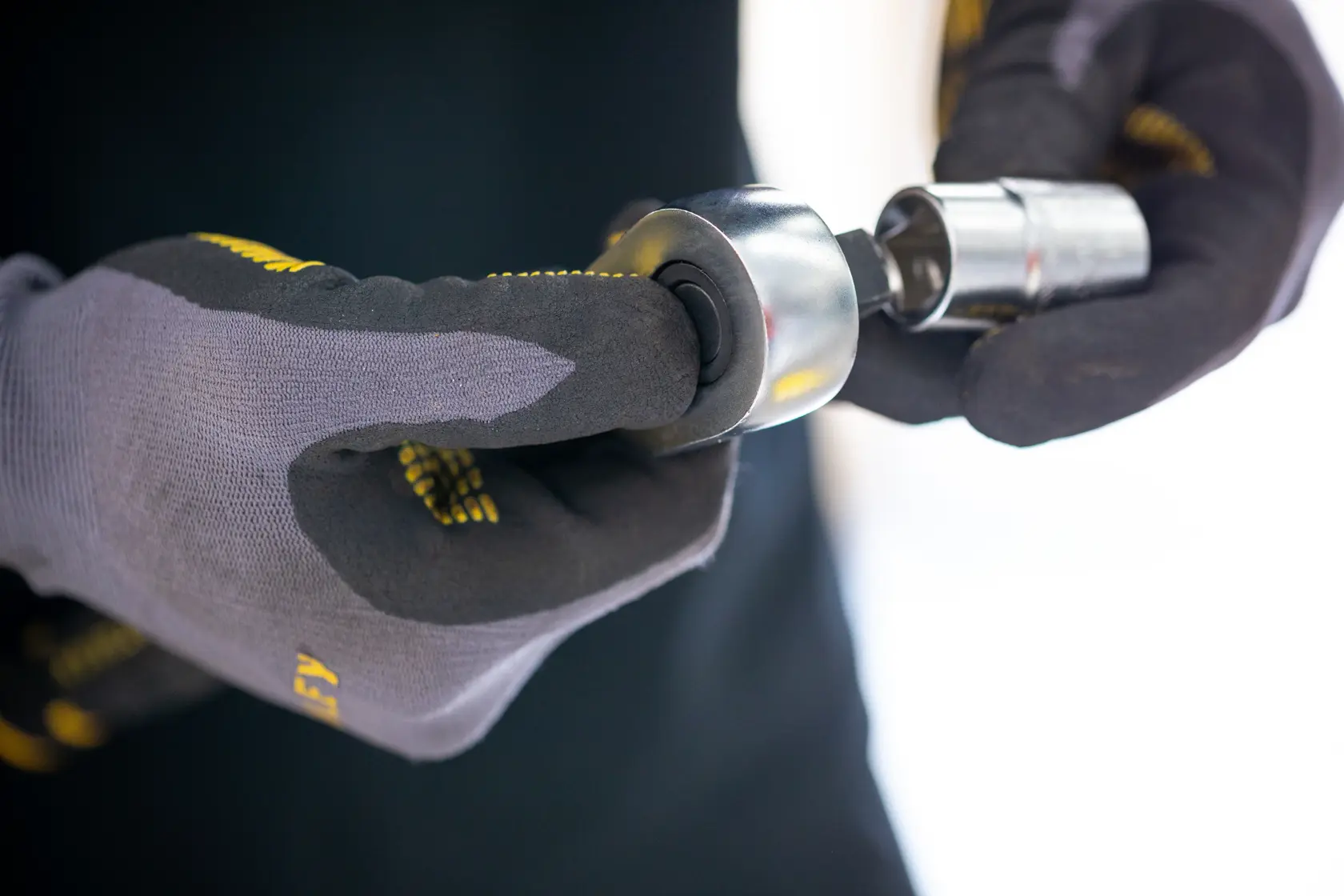Stanley FMMT17223-0 socket being held by gloved hands, close-up photo.