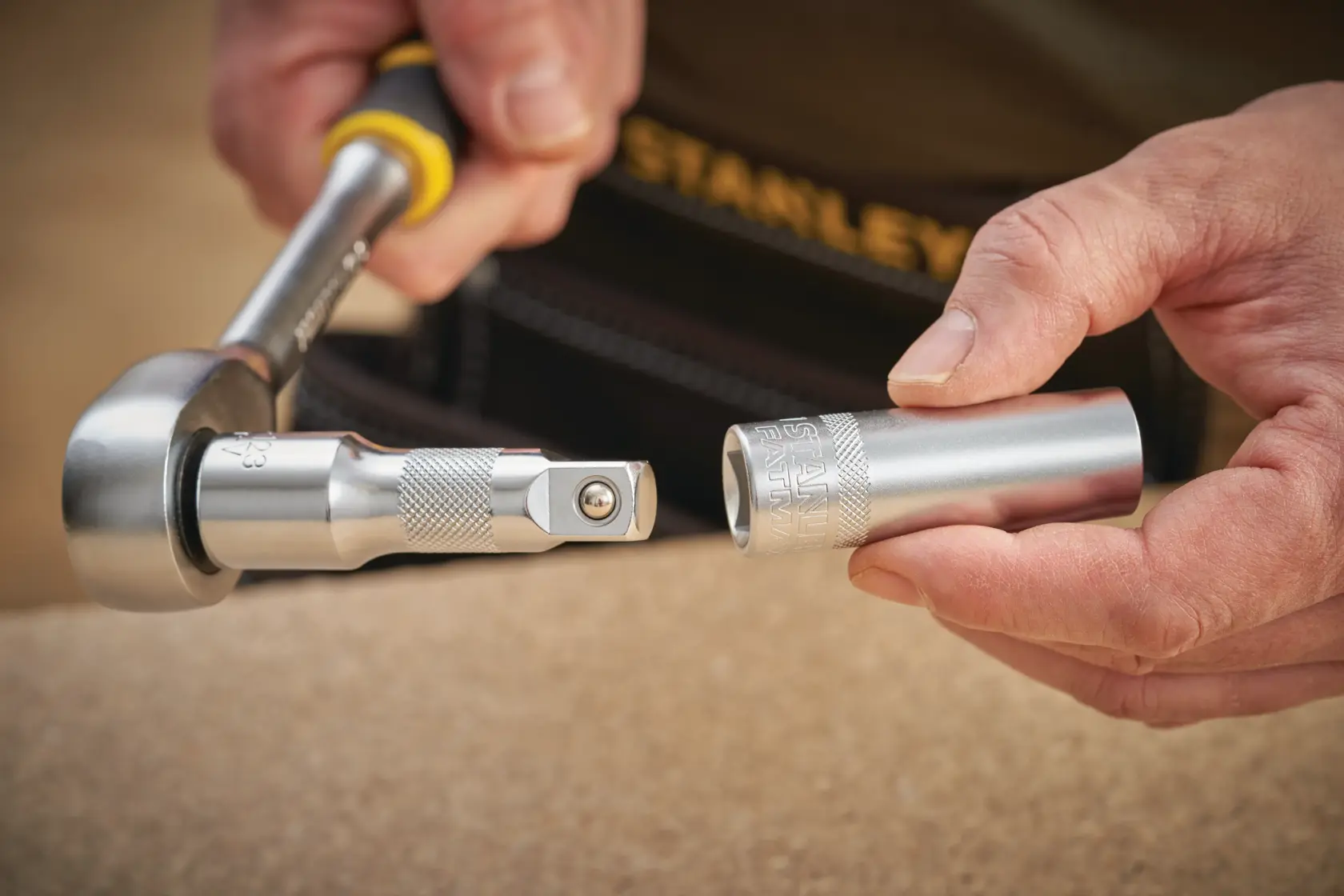 STANLEY FMMT17967-0 socket wrench and socket held in hand in close-up photography.