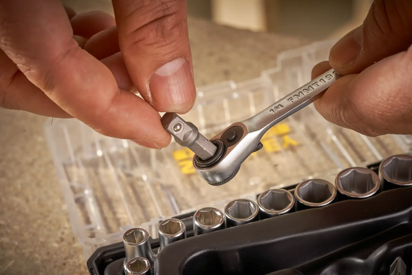 STANLEY FMMT19101-0 ratchet and socket set in use, close-up photography of hand inserting adapter.