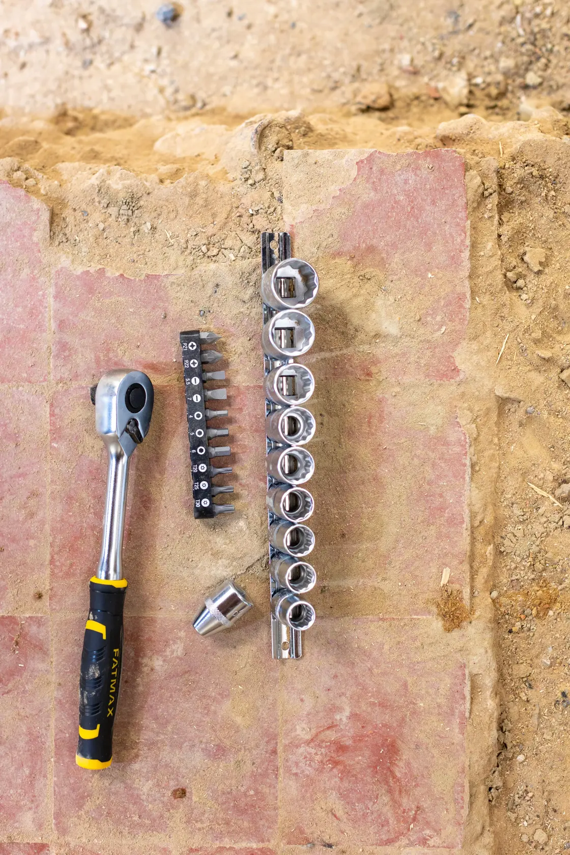 STANLEY FMMT82679-0 socket and bit set with ratchet, viewed from above on construction surface.