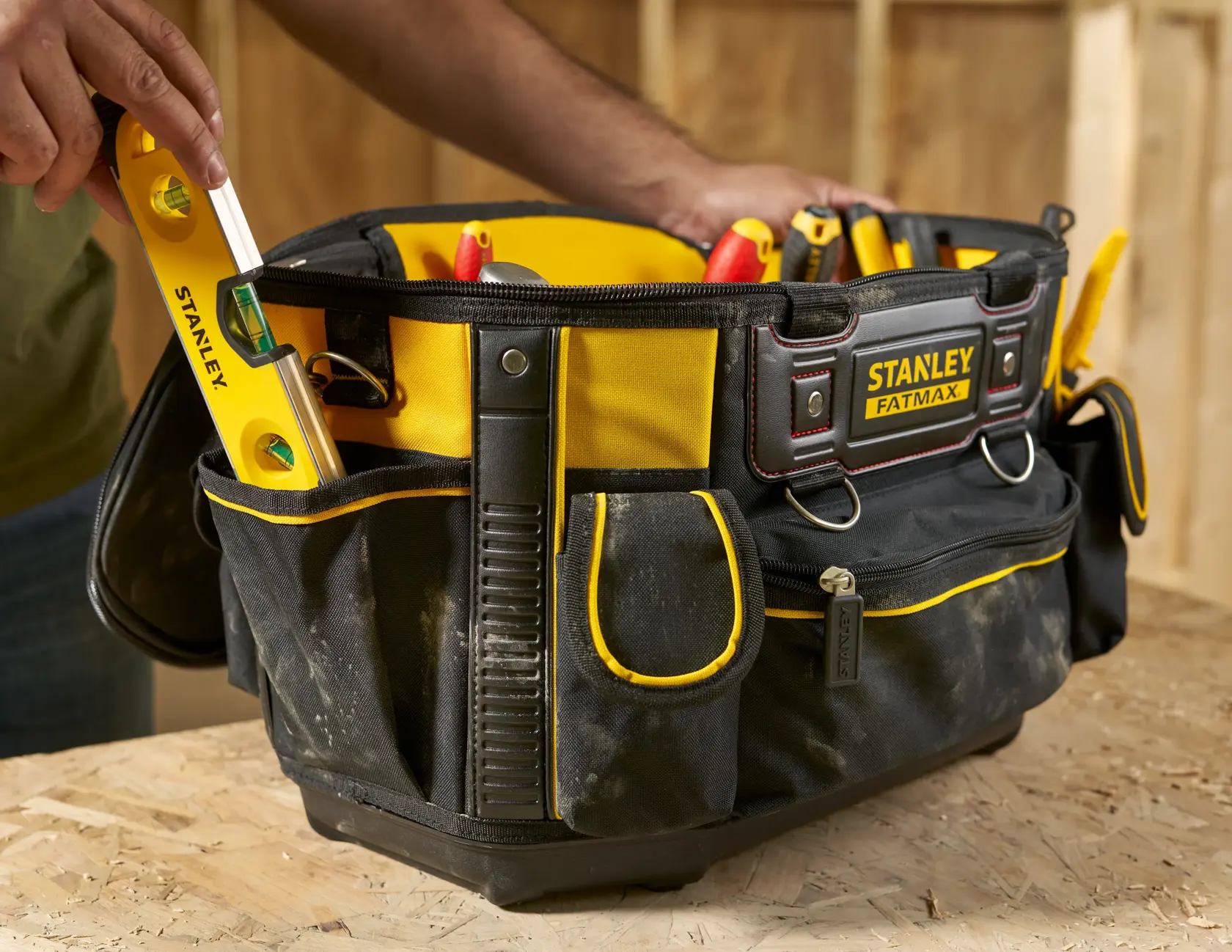 STANLEY FMST1-70749 tool bag with yellow trim filled with hand tools, front angle photo.
