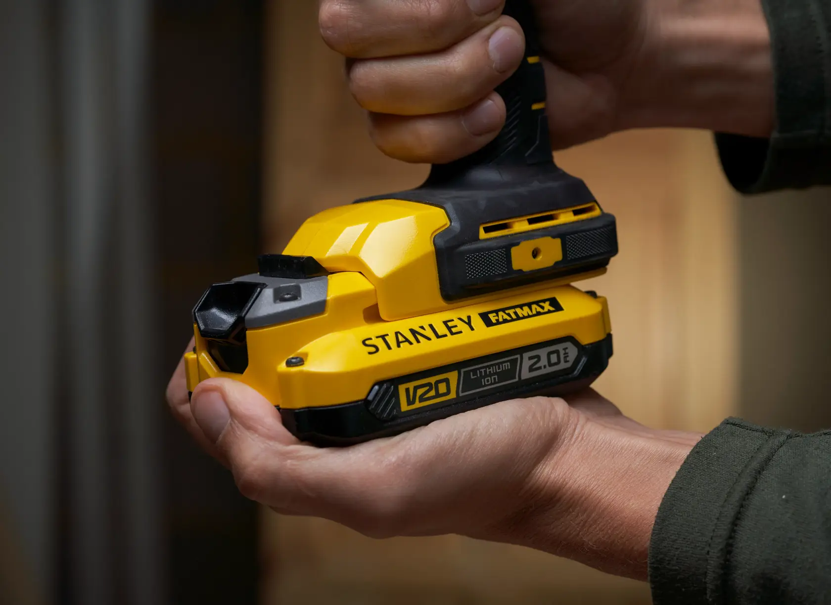 STANLEY SFMCL050B 18V FATMAX V20 Pivot Light, yellow handheld, close-up in hand.