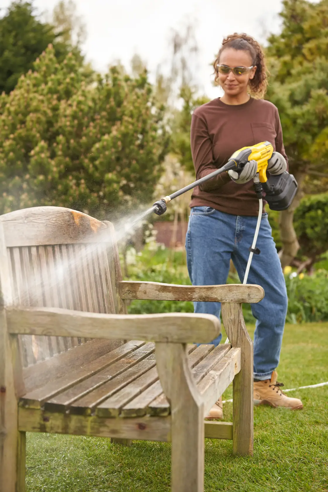 Stanley cordless pressure washer with yellow and black design, long nozzle, and battery pack.
