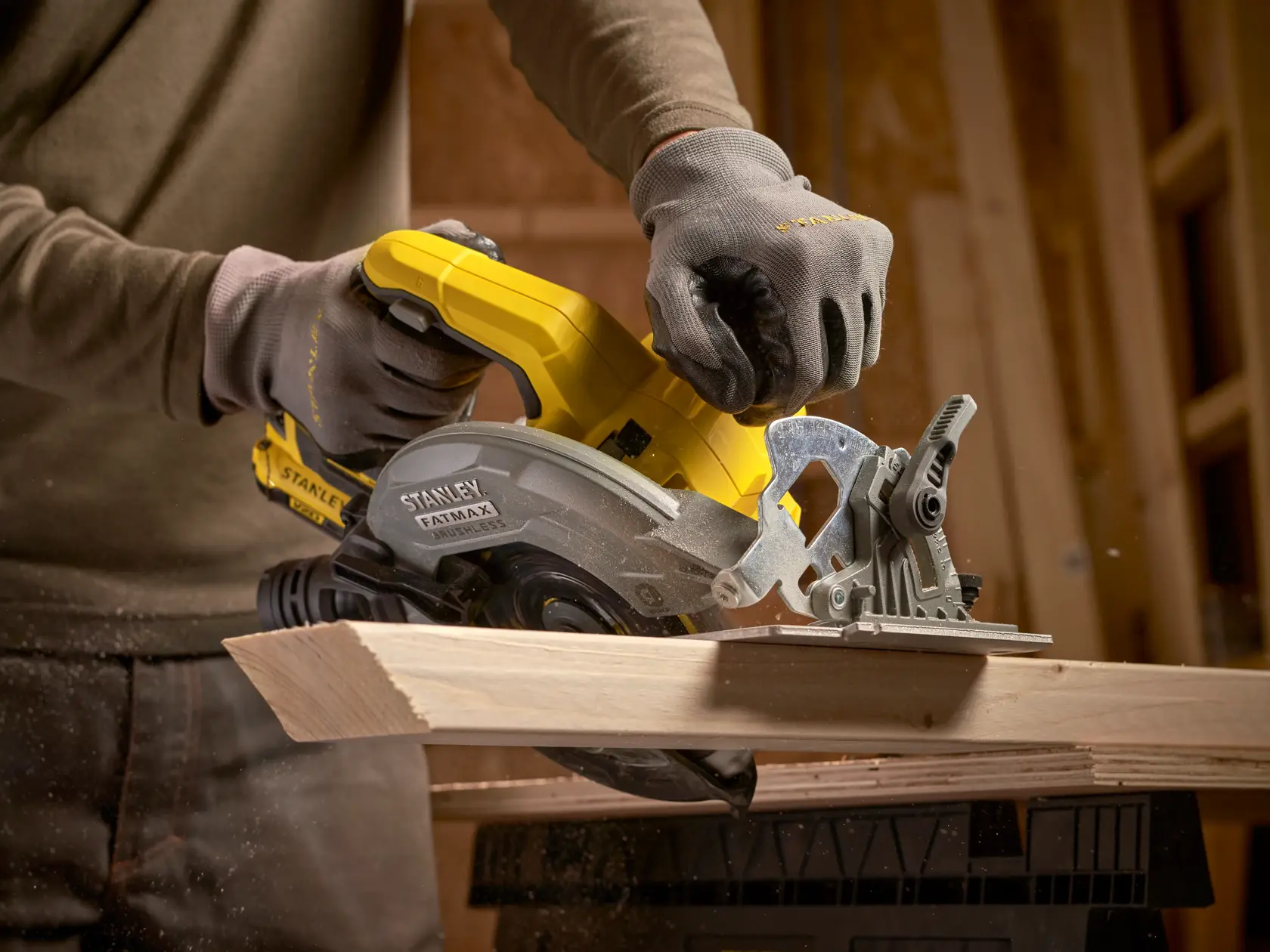 STANLEY SFMCS550M2K circular saw in use cutting wood, yellow and gray body, close-up photography.