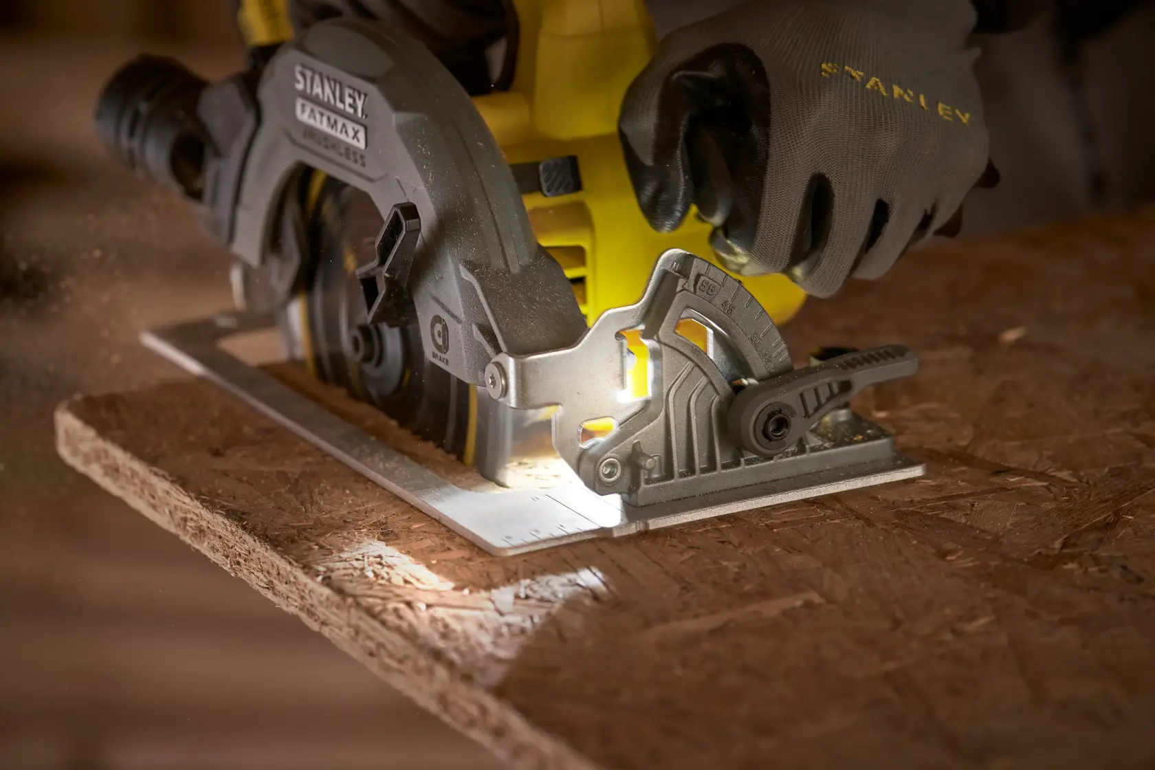 STANLEY SFMCS550M2K circular saw cutting wood, close-up showing blade and integrated LED light.