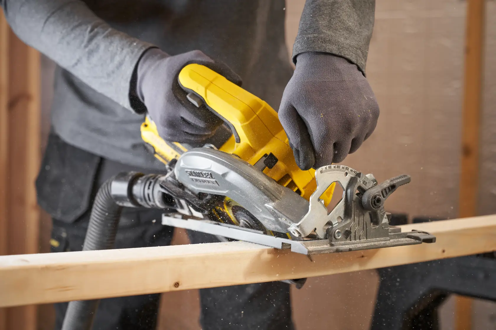 STANLEY SFMCS551B cordless circular saw cutting wood, shown in use from side angle.