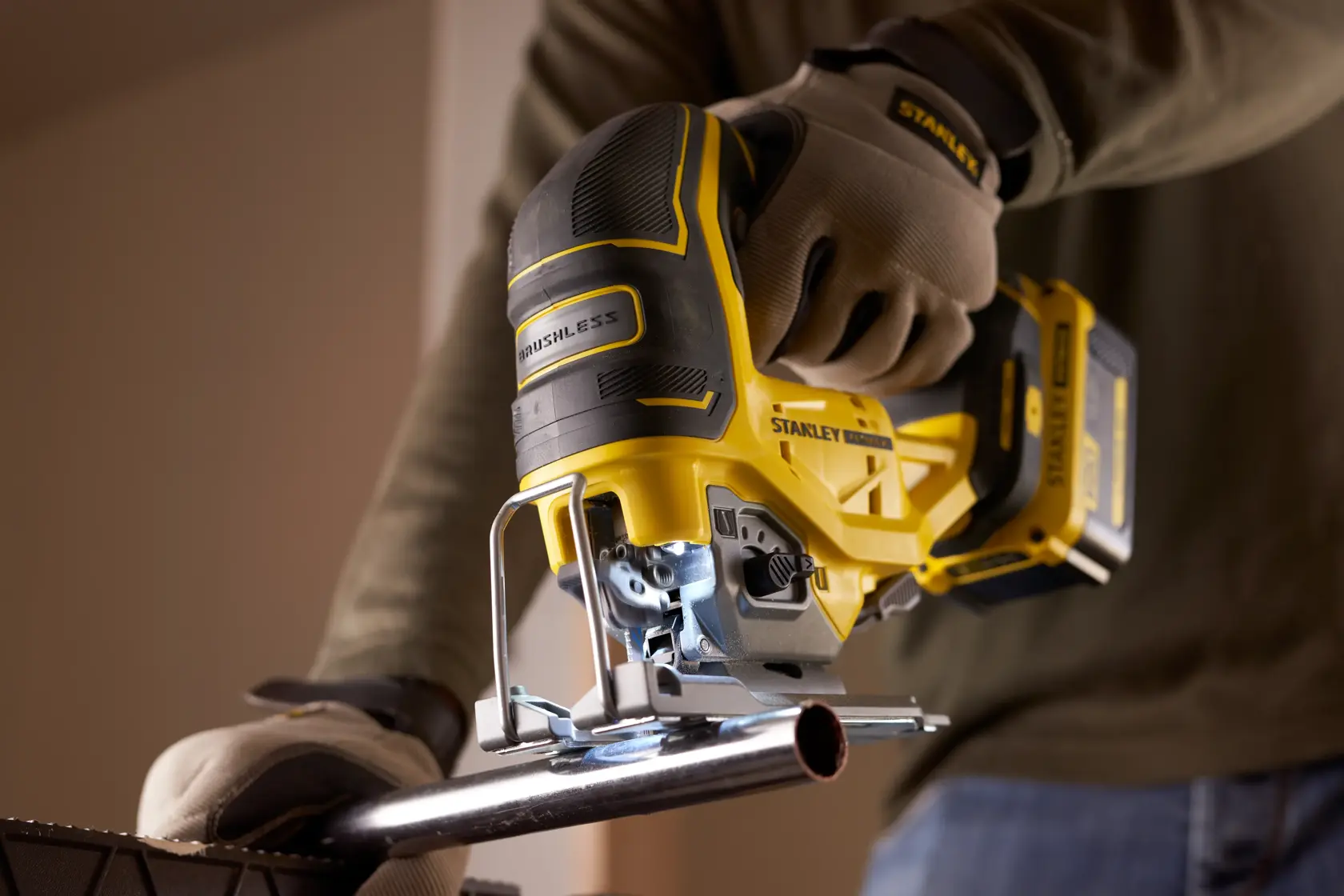 STANLEY SFMCS650B scie sauteuse brushless FATMAX V20 18V coupant un tuyau métallique, photo rapprochée.