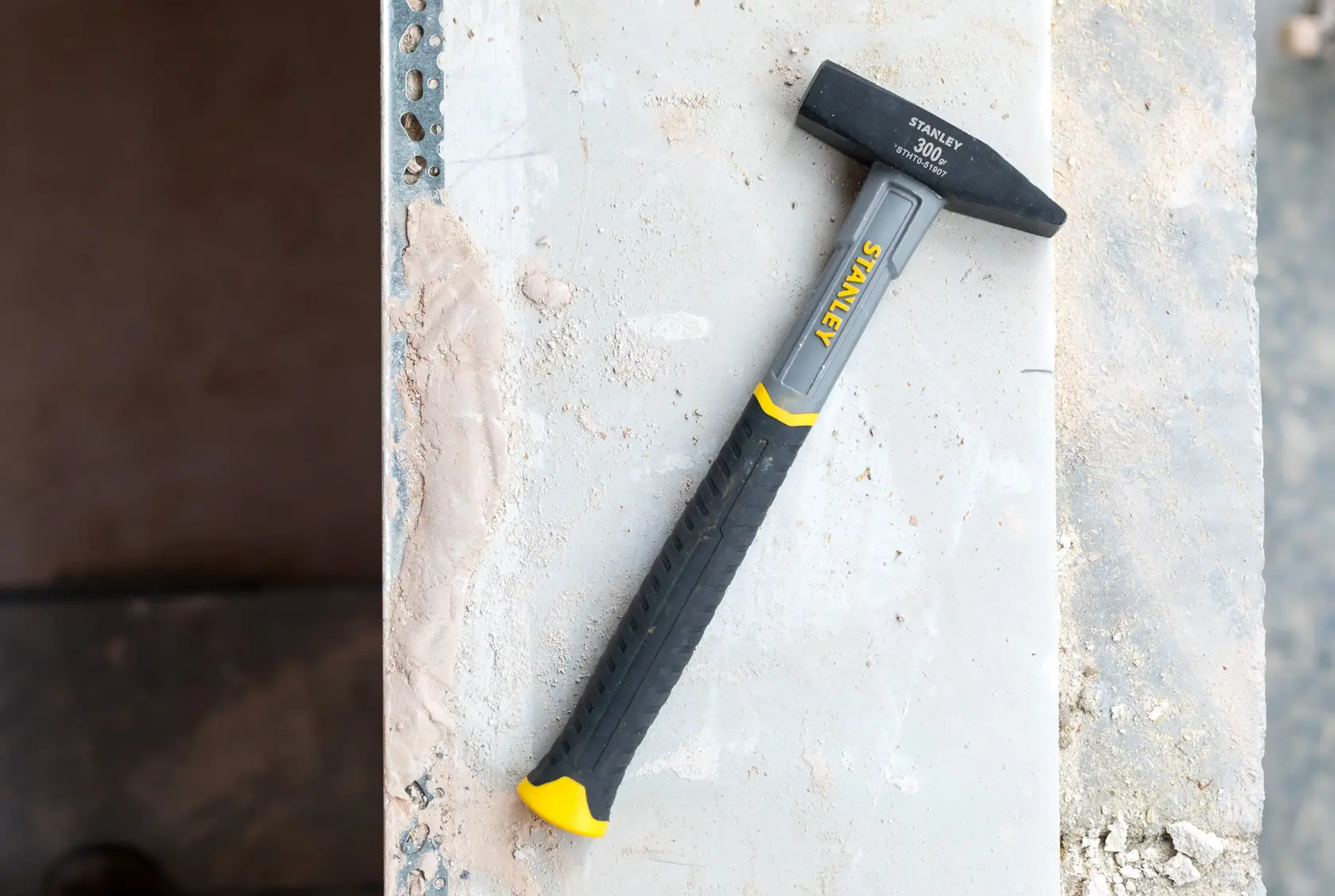 Stanley 300g hammer with a black and yellow handle and metal head shown on white background.
