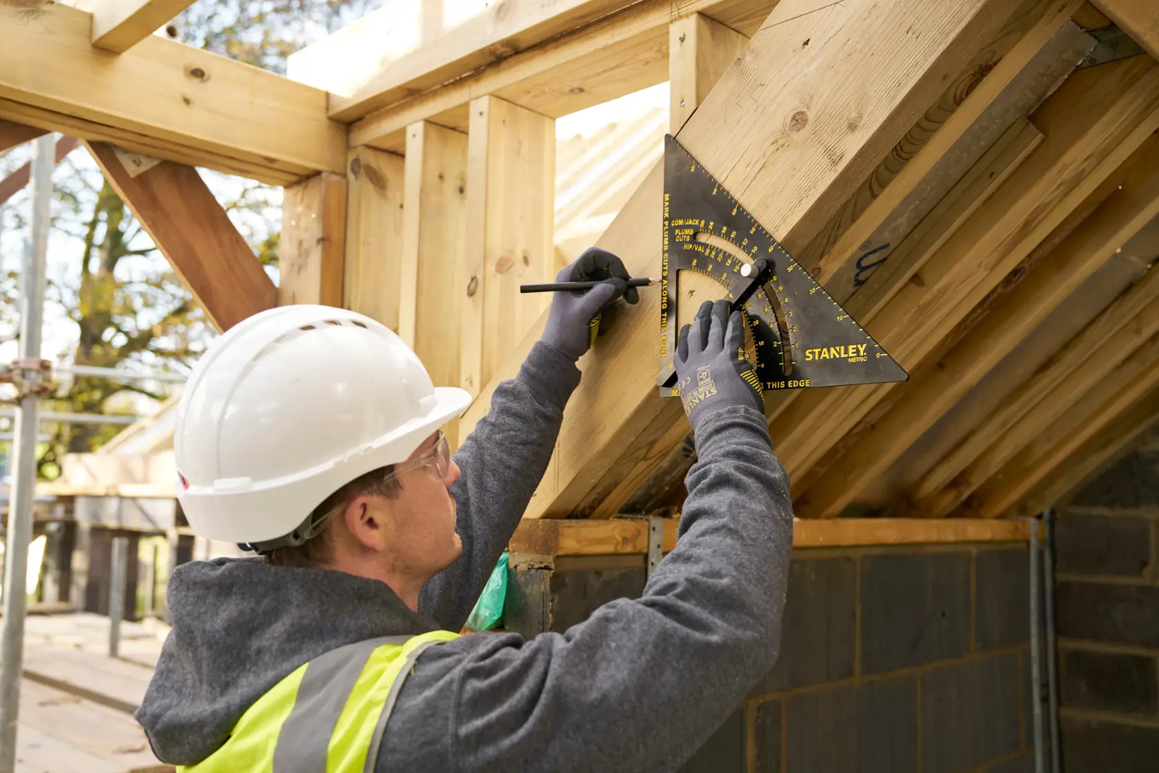 STANLEY STHT46054-0 roofing square used to mark angles on timber during roof construction.