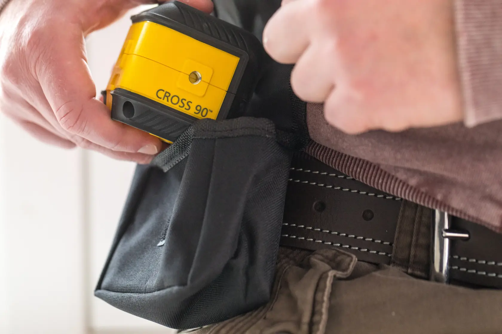 STANLEY STHT77592-1 laser level kit with mounting bracket and black carrying pouch, front view on white background.