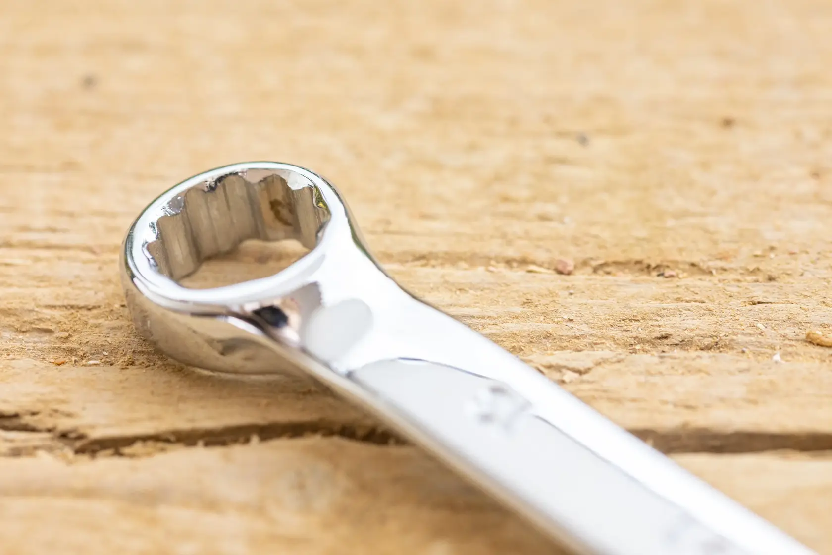STANLEY STMT82842-0 combination wrench close-up on wood, showing polished chrome finish.