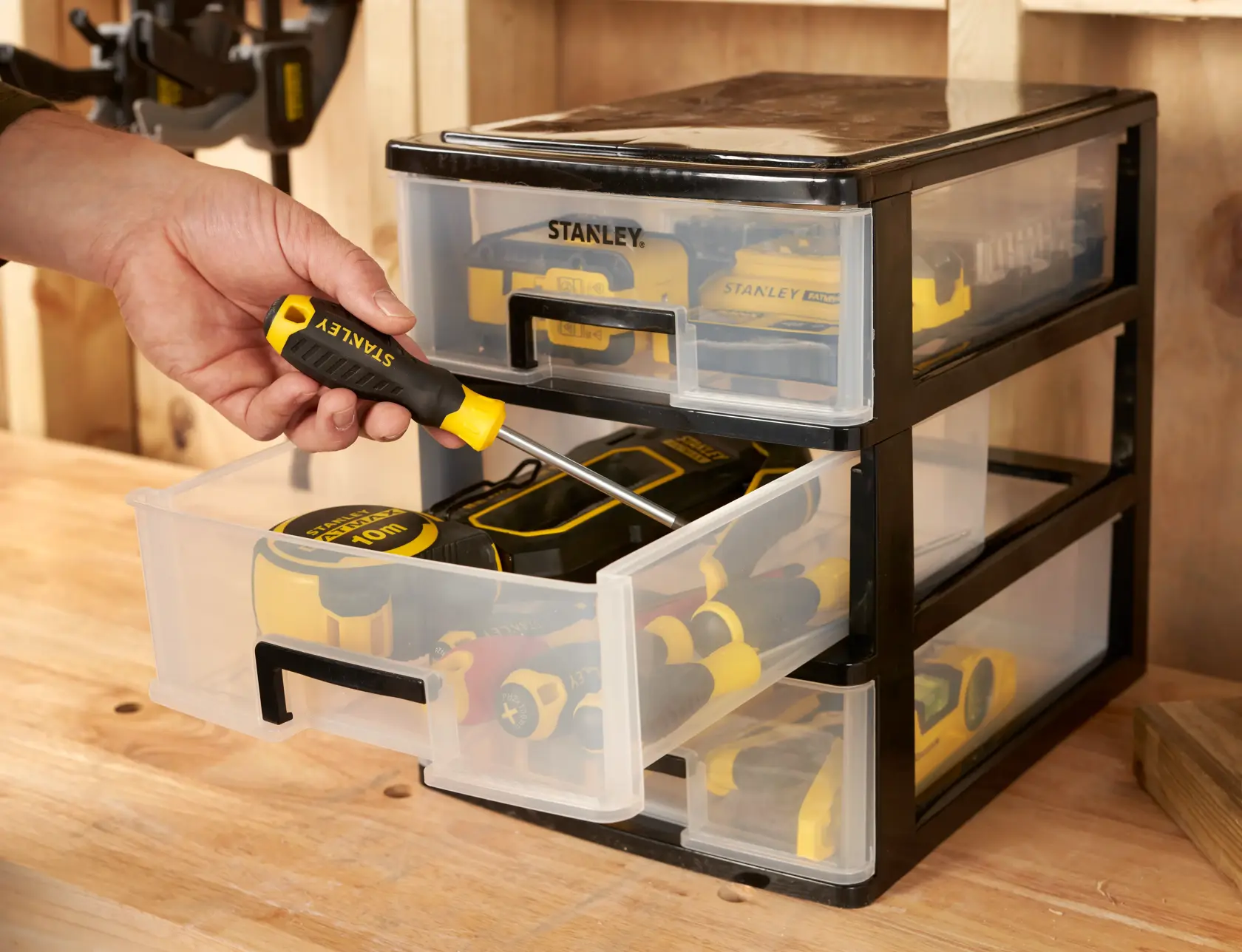 STANLEY STST40712-1 storage drawers filled with tools, photo of drawer being opened on workbench.