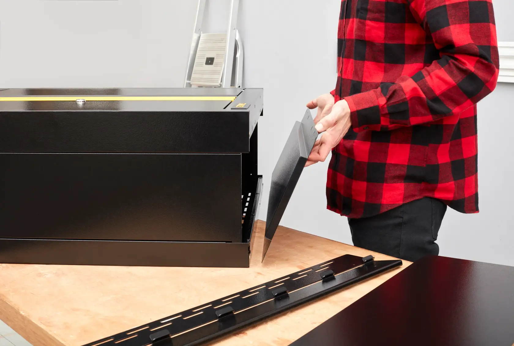 STANLEY STST97598-1 toolbox assembly photo, black steel panels on workbench, side view.